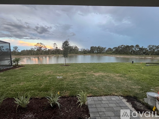 A backyard with a pond and a walkway.