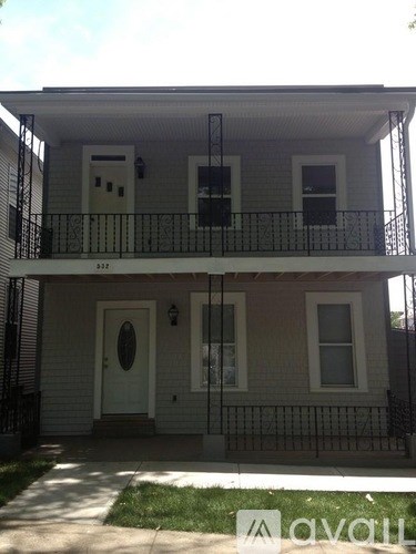 A two story house with a balcony on the second floor.