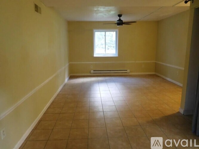 A room with a tiled floor and a window.