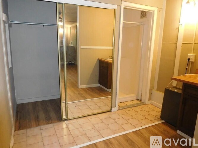 A room with a white door and a mirrored door.