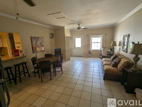 A living room with a dining table and chairs.