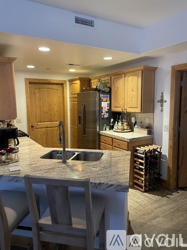 A kitchen with wooden cabinets and a granite countertop.