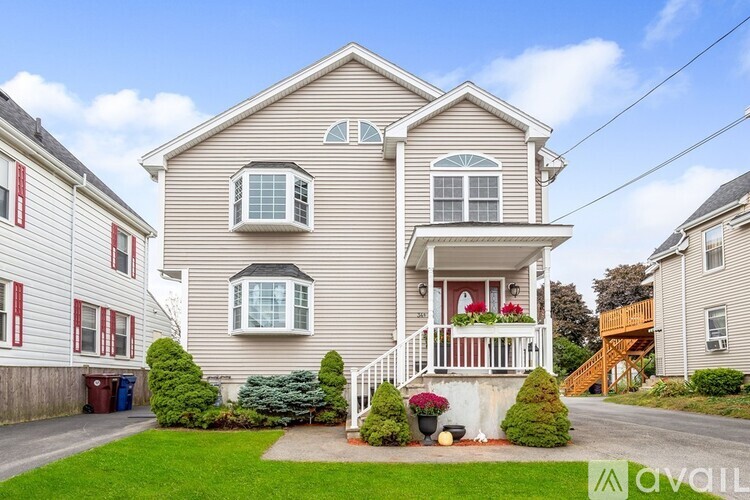 A two-story house with a front porch and a garage.