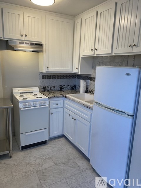 A kitchen with a white fridge and a white stove.