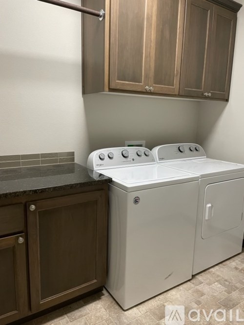 A white dishwasher and a white stove top oven in a kitchen.