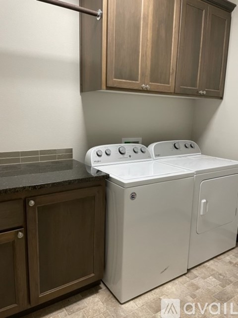 A white dishwasher and a white stove top oven in a kitchen.