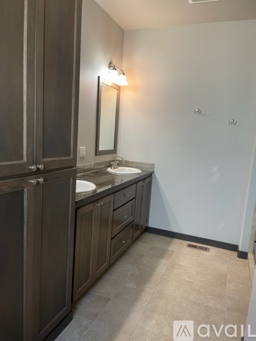 A bathroom with a sink and a mirror.