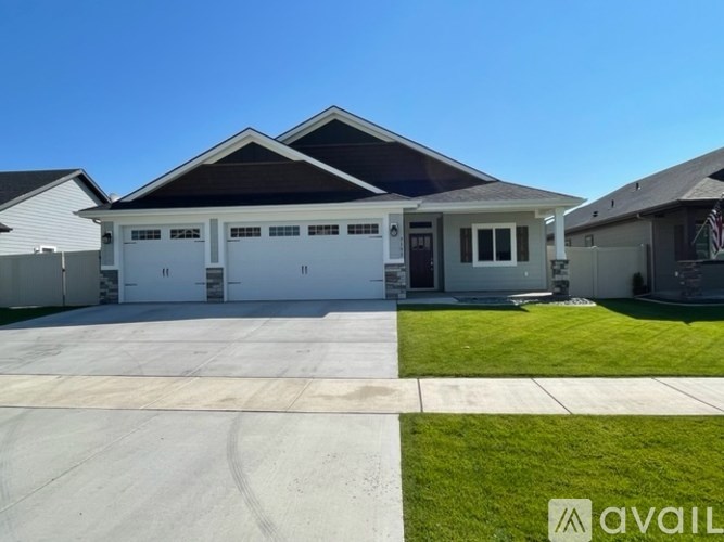 A house with a white garage door is for sale.