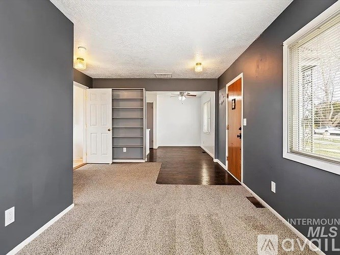 A room with grey walls and a carpeted floor.