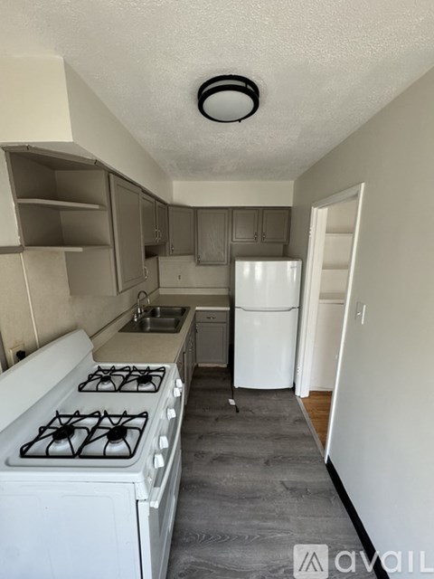 A small kitchen with a white stove and a white refrigerator.