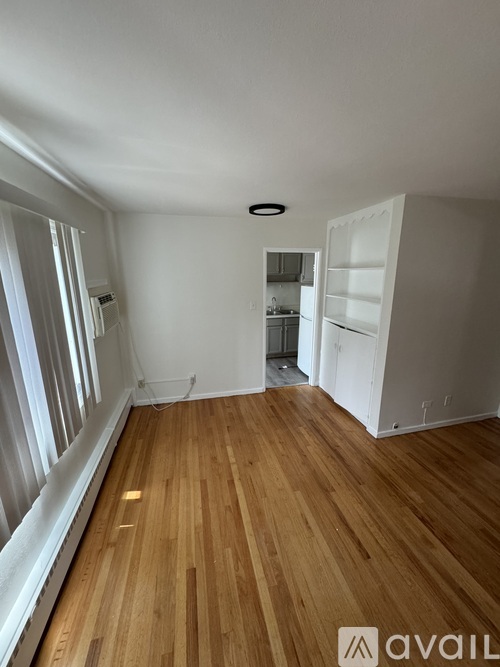 A room with wooden floors and white walls.