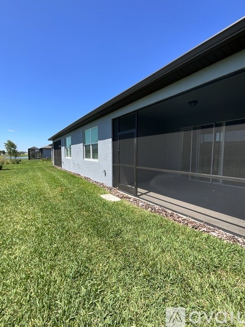 A building with a grassy area in front of it.