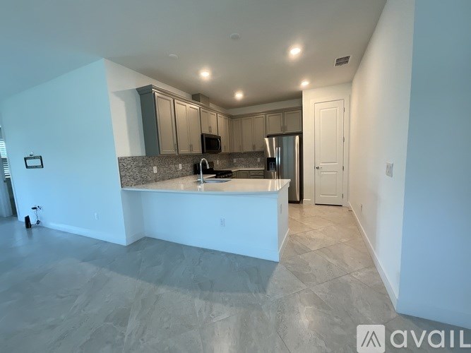 A kitchen with a countertop and cabinets is available for rent.