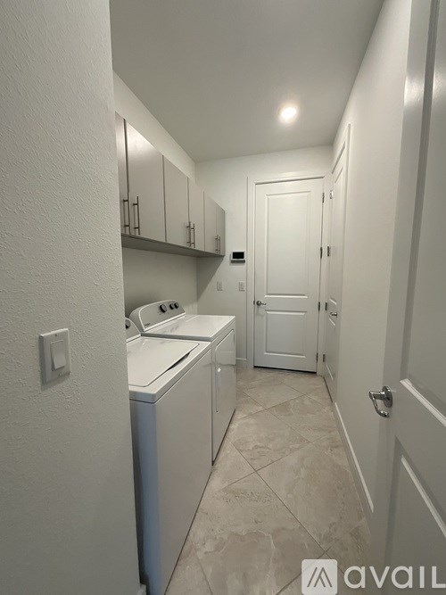 A small laundry room with a washer and dryer.