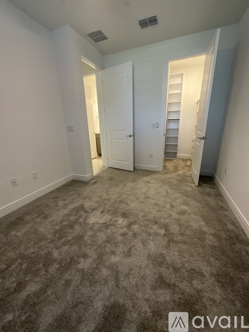 A room with carpeted floor and white walls.
