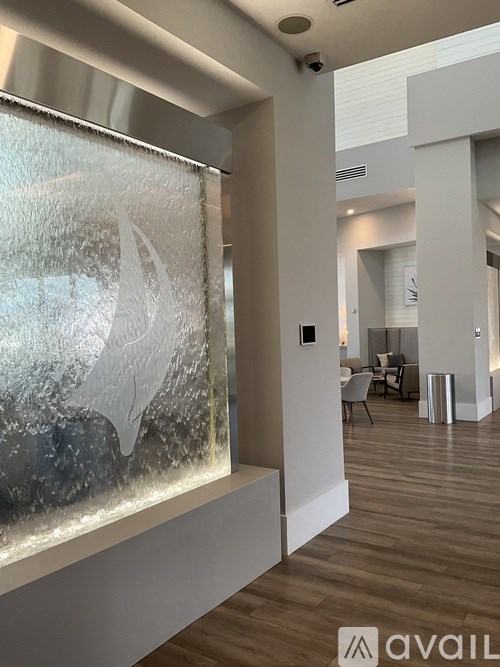 A modern interior space with a large window and a wooden floor.