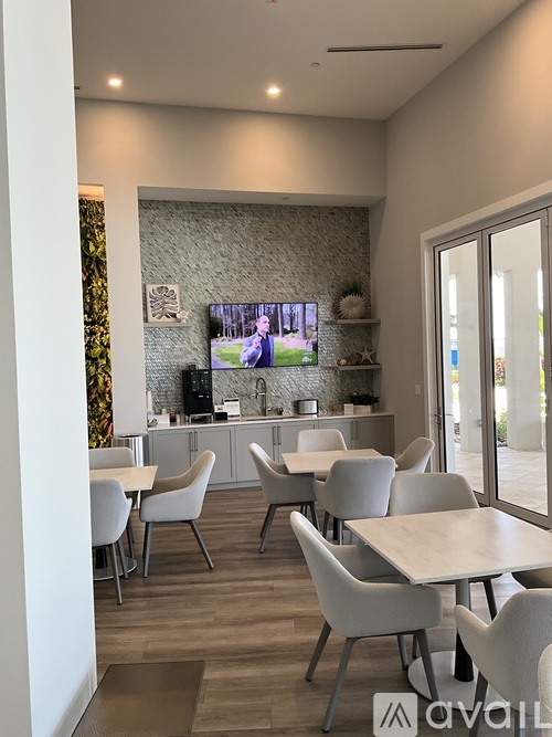 A modern dining area with a TV screen showing a boxing match.