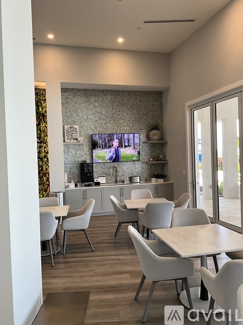 A modern dining area with a TV screen showing a boxing match.