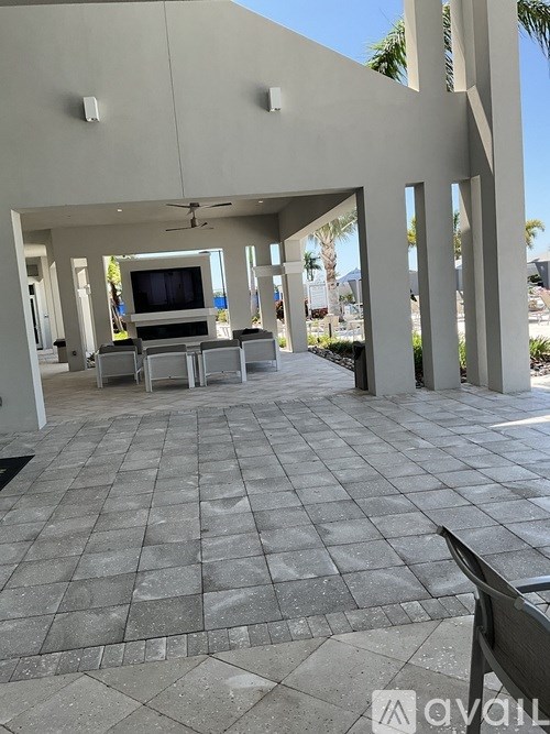 A patio with a television and chairs.