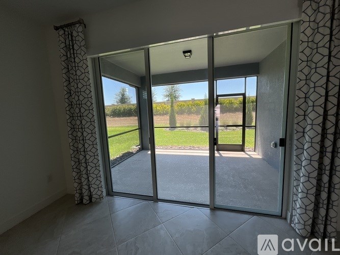 A room with a sliding glass door leading to a patio.