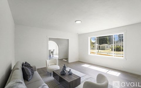 A living room with a grey couch and a coffee table.