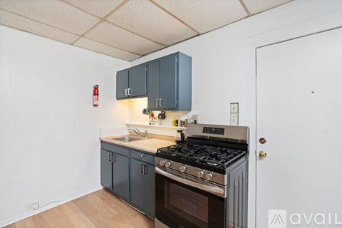A kitchen with a stove and cabinets.