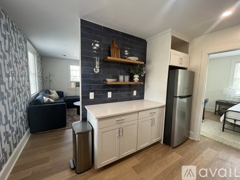 A kitchen with blue cabinets and a stove top oven.