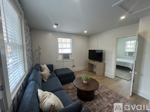 A bedroom with a bed, desk, and chair.