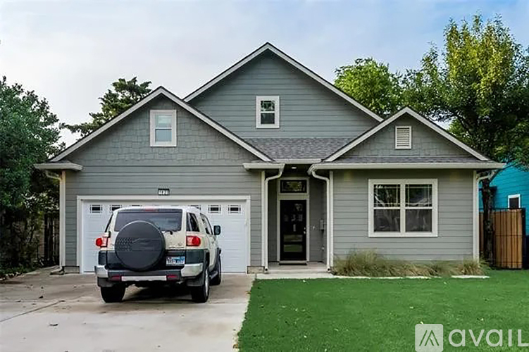 A house with a car parked in front of it.