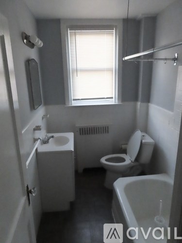 A small bathroom with a toilet, sink, and bathtub.