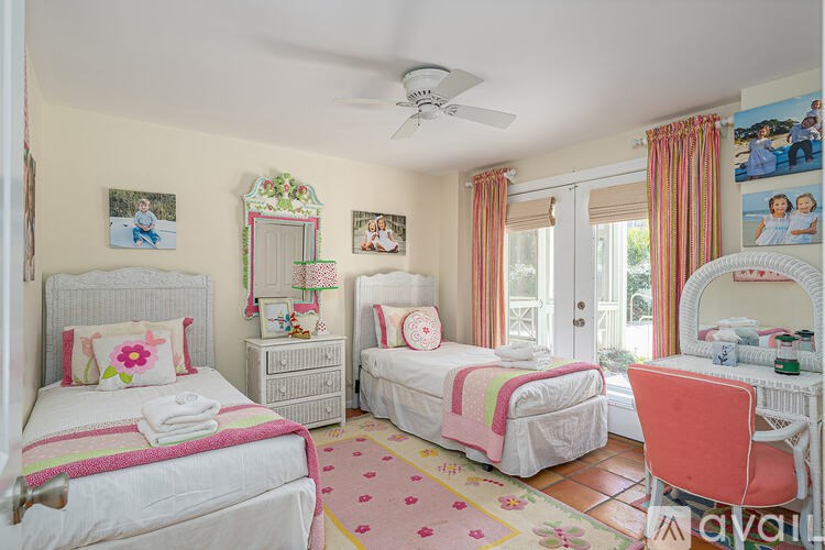 A bedroom with two beds and a dresser.