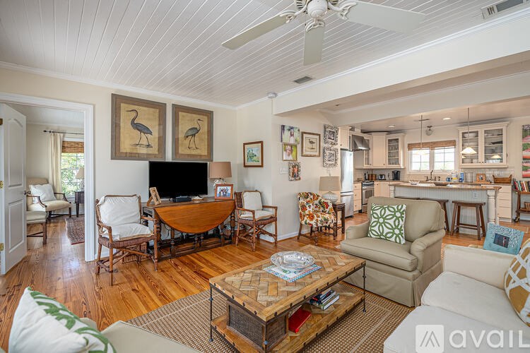 A living room with a wooden floor and furniture.