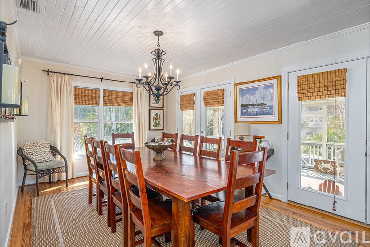 A dining room with a wooden table and chairs.