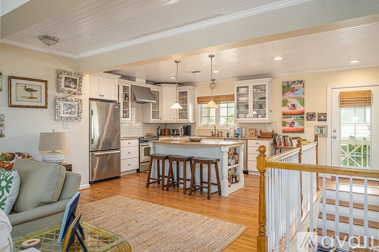 A kitchen with a refrigerator, stove, and sink.