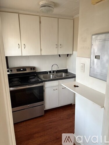 A kitchen with white cabinets and a stainless steel oven.