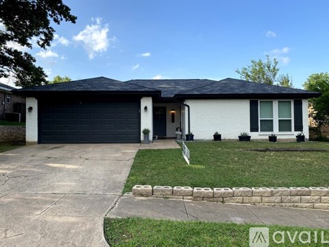 A house with a garage and a driveway is for sale.