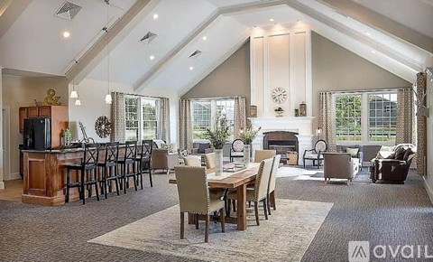 A spacious living room with a fireplace and a dining table set up.