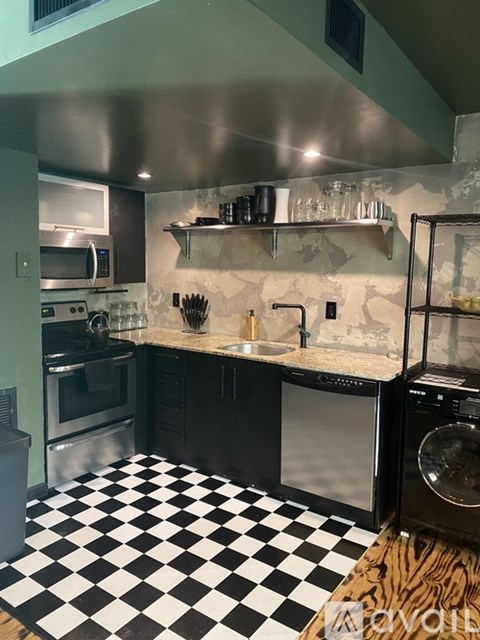 A black and white checkered floor in a kitchen.