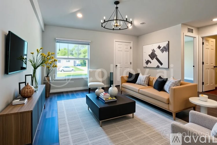A living room with a brown sofa, a coffee table, and a television.