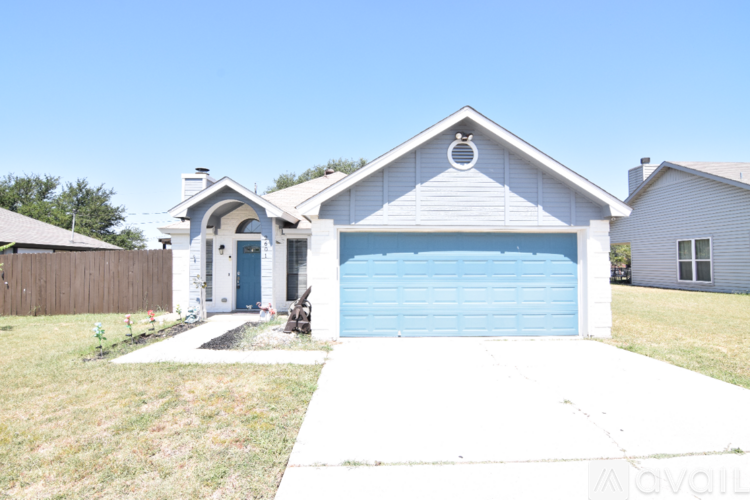 A house with a blue garage door is for sale.