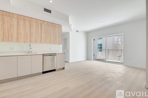 A modern kitchen with wooden cabinets and a white countertop.