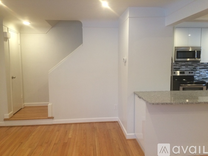 A kitchen with a staircase leading to the upper floor.