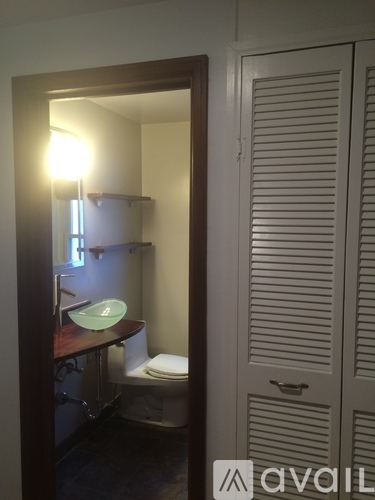 A bathroom with a toilet and a mirror.