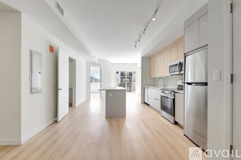 A kitchen with stainless steel appliances and wooden cabinets.