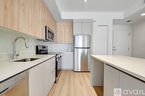 A kitchen with wooden cabinets and stainless steel appliances.