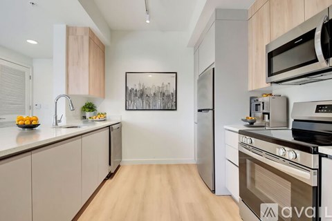 A kitchen with wooden cabinets and a fridge.