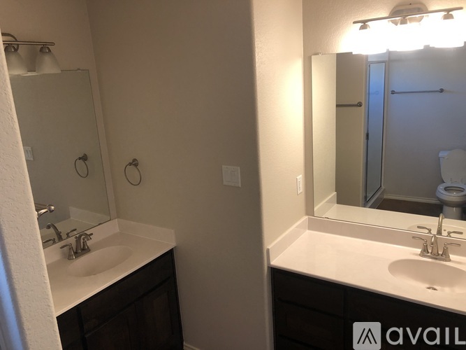A bathroom with a sink, mirror, and toilet.