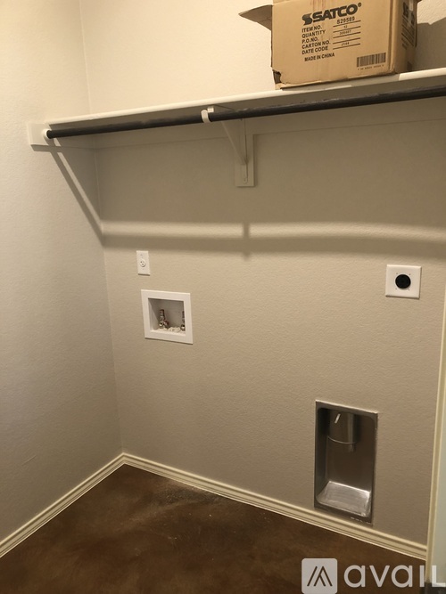 A cardboard box with the label "SSATCO" is sitting on a shelf above a wall socket.