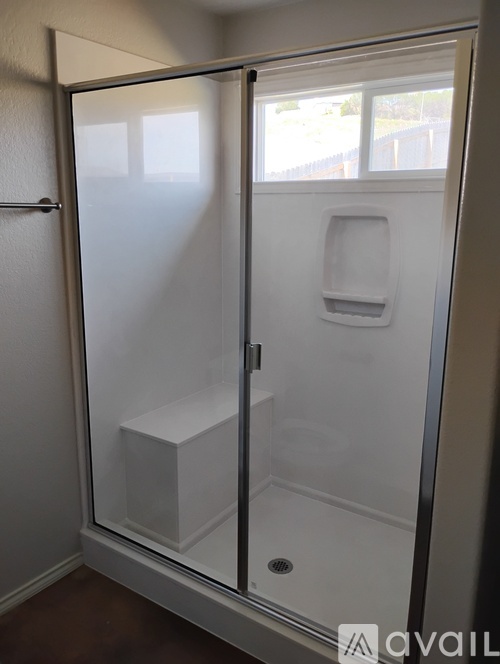A glass door with a handle and a white square object inside.