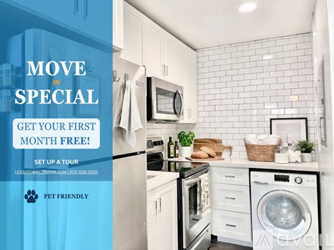 A modern kitchen with a refrigerator, microwave, and oven, with an advertisement for a free first month of rent.
